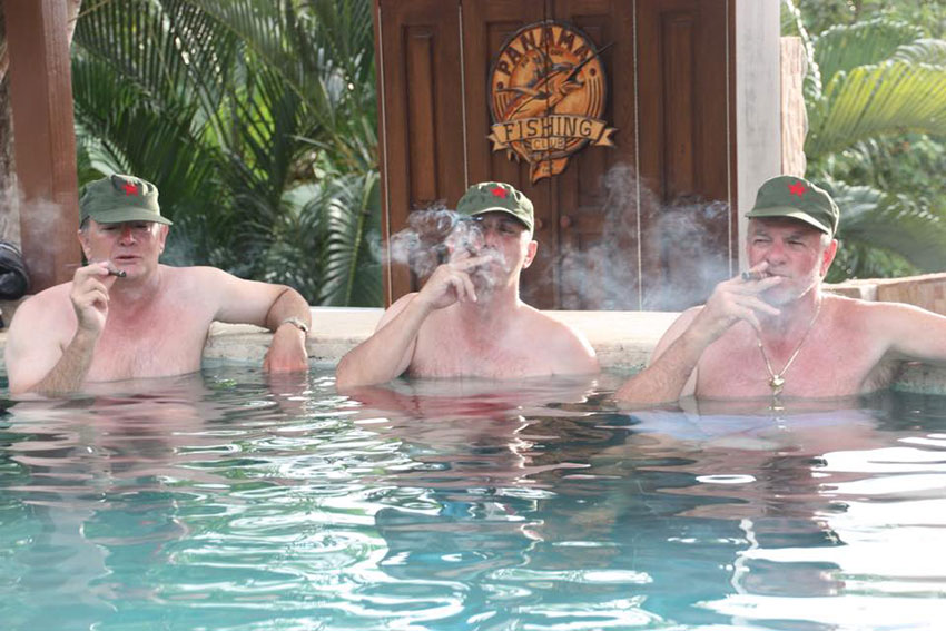 Guys having a cigar in our resort pool.